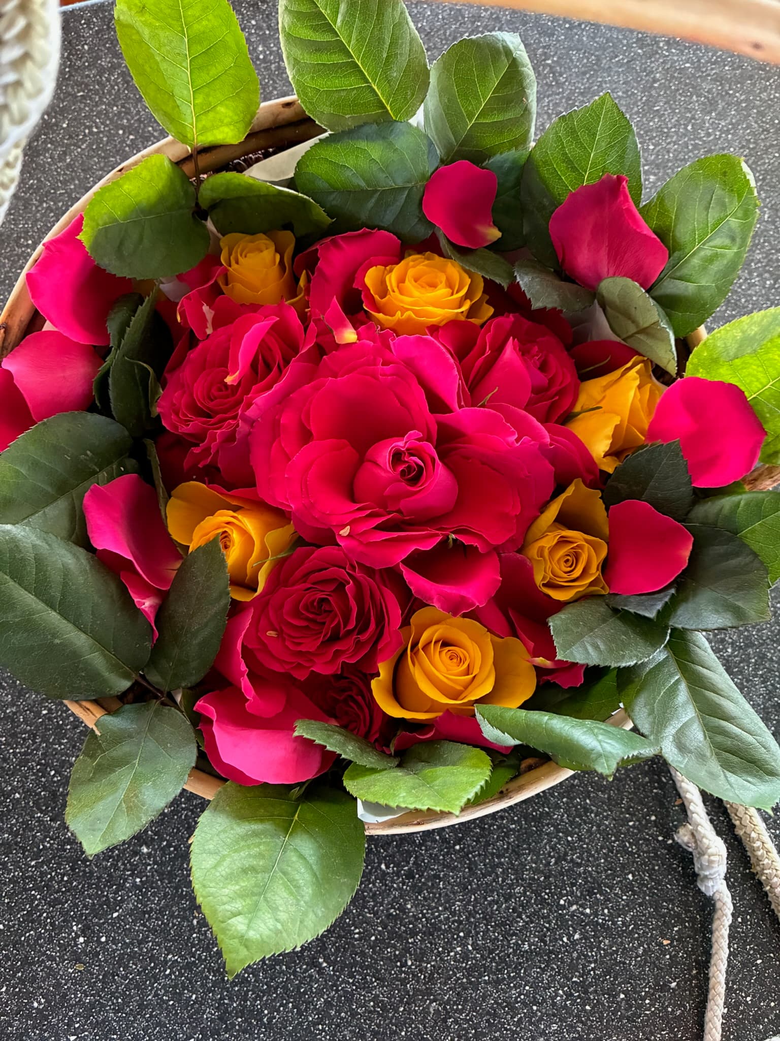 A woven basket of crimson and amber roses, brought aboard for a committal.